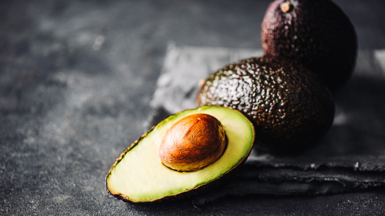 Sliced avocado with pit in the center