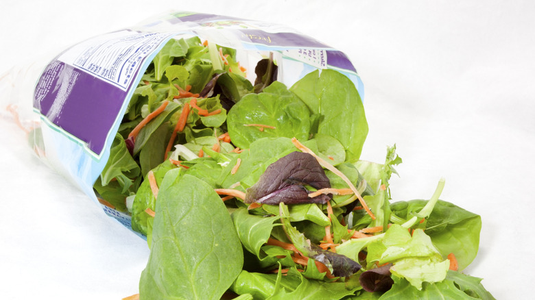 Salad spilling out of plastic bag
