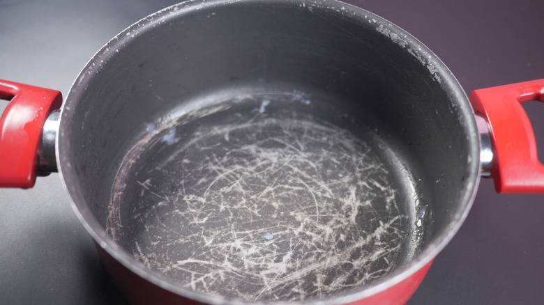 A nonstick pot with scratches all over the bottom