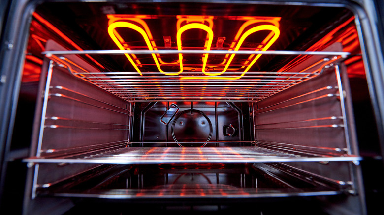 Interior of a clean oven with a heating element glowing orange