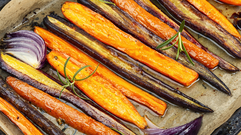 Slender roasted carrots with rosemary and onion, still in the pan