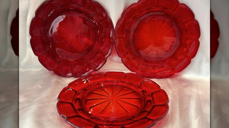 Three vintage dessert plates made of clear red glass