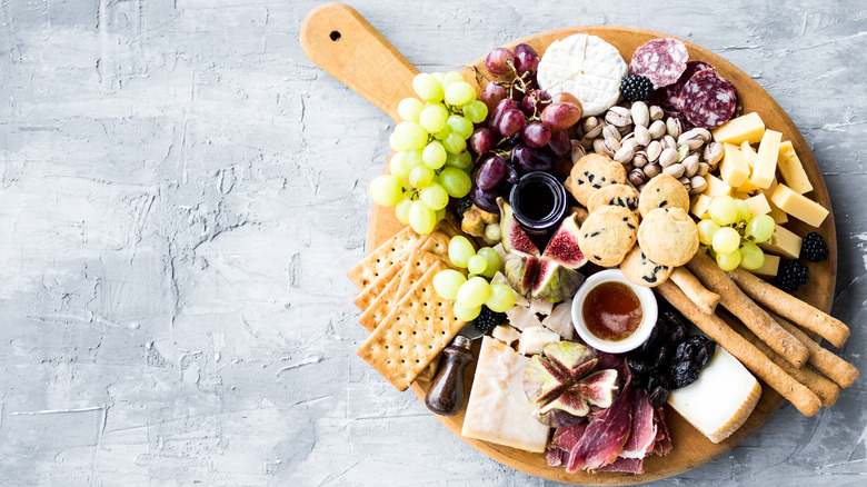 A charcuterie board against a gray background