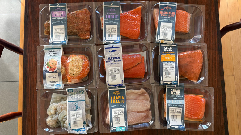 Packages of assorted fresh seafood items from Aldi on a table
