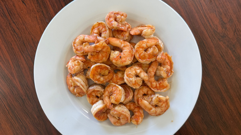 A plate of cooked shrimp on a white plate