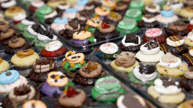 A large tray of Baked by Melissa mini cupcakes in different colors