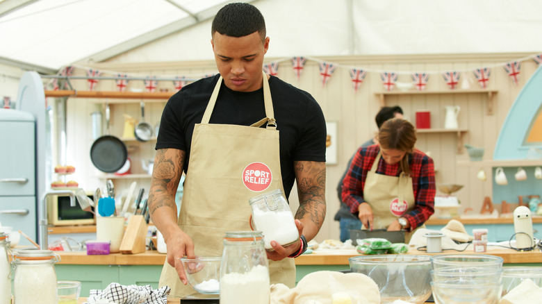 Jermaine Jenas weighing flour during a challenge on The Great British Bake Off