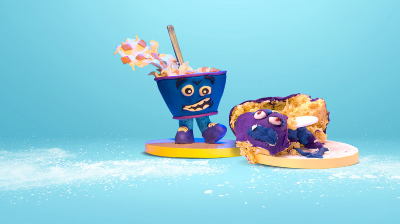 A still from Netflix's "Nailed It!" showing a beautiful small cake next to a cake that has fallen apart.