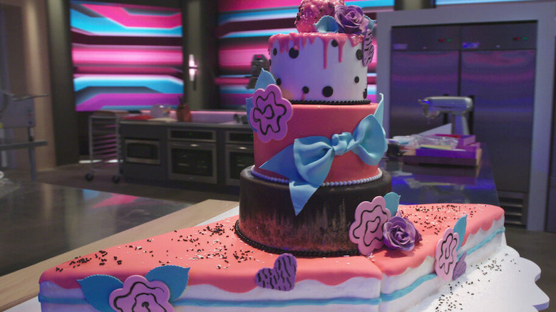 A beautiful four tiered cake from "Sugar Rush" on a table