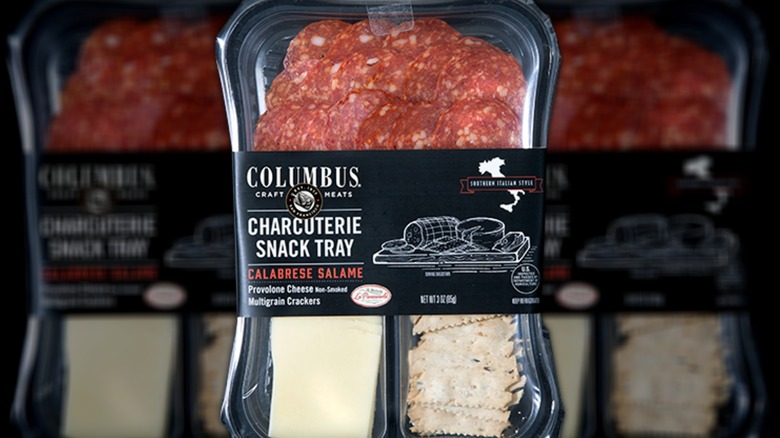 A package of Columbus charcuterie snack tray, calabrese salame, showing cheese, meat, and crackers