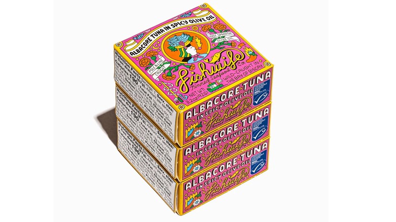 Three pink and yellow boxes of Fishwife albacore tuna in spicy olive oil