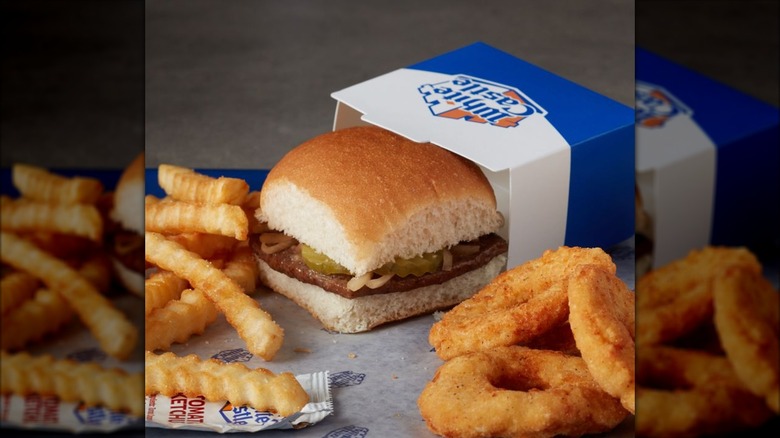 An original White Castle slider with sides of french fries and chicken rings