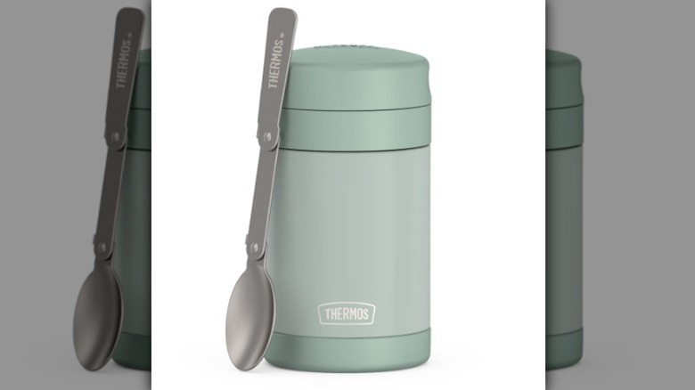 Thermos food jar with spoon on white background