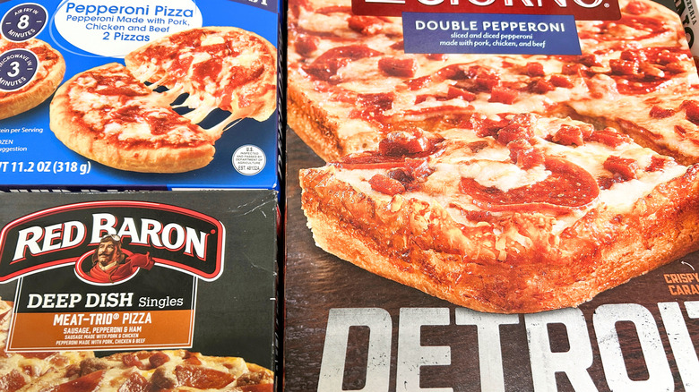 Close up of three types of deep dish frozen pizza