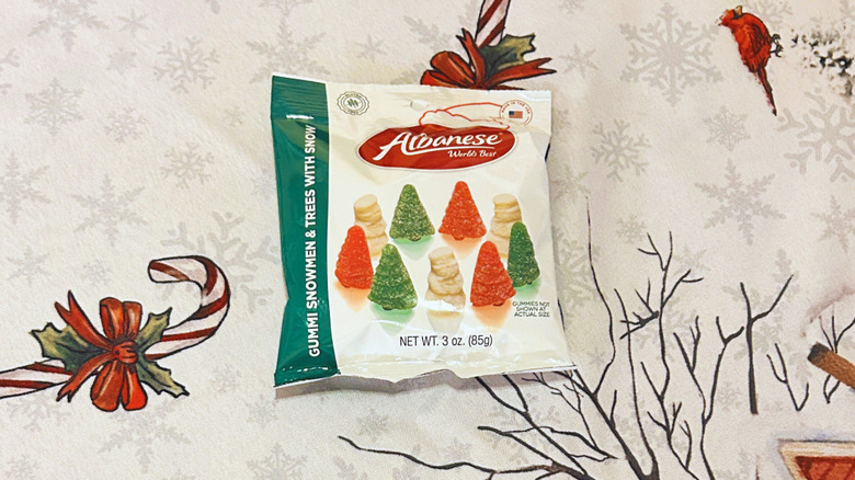 Albanese Gummi Snowmen and Trees with Snow on top of a festive red and white background