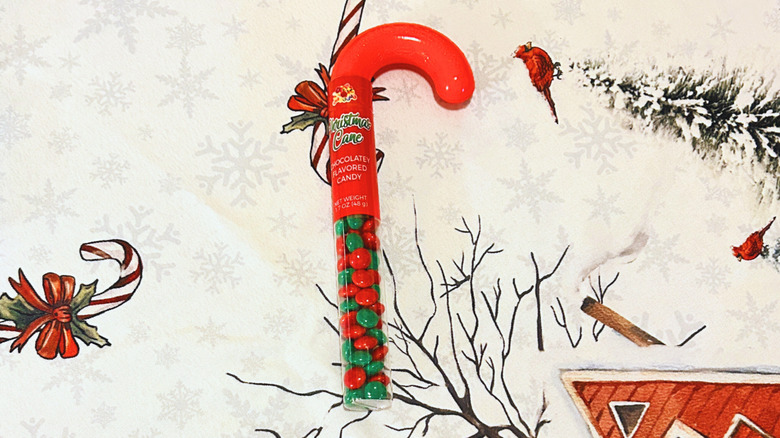 Christmas candy-filled candy cane on top of a festive red and white background