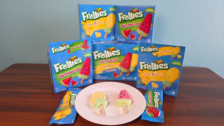 Frollies watermelon and pineapple fruity ice pops boxes on a table and pops on a plate