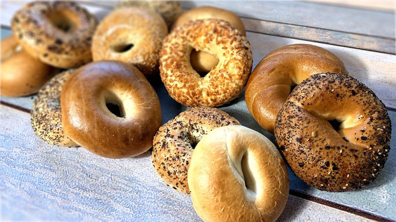 assorted bagels piled on table