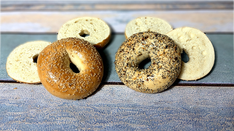 two whole and two sliced bagels on table