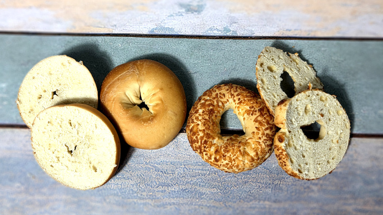 two whole and two sliced bagels on table
