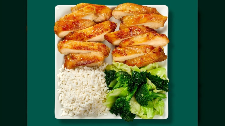 Panda Express' Double Grilled Teriyaki Chicken, white rice, and super greens on a green background