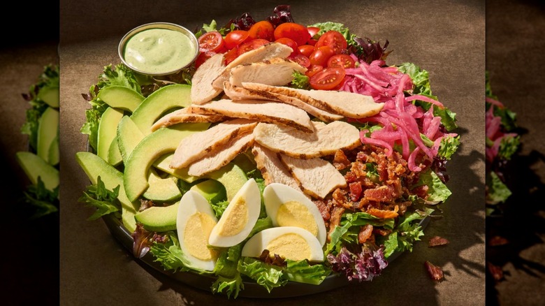 Panera's Green Goddess Chicken Cobb Salad on a brown background