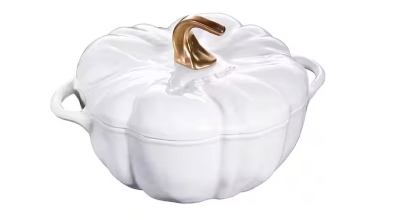 A white Cocotte shaped like a pumpkin with a golden stem