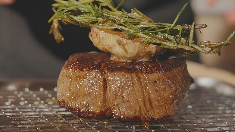 A juicy filet mignon with garnish, resting