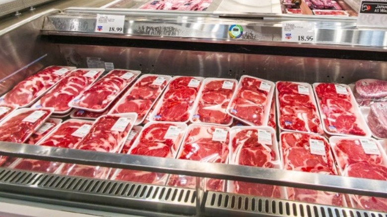 Rows of prepackaged meats in a supermarket freezer