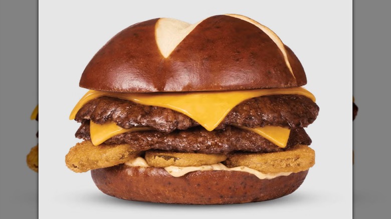 A Culver's Fried Pickle Pub Burger on a gray background