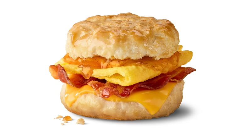A McDonald's Honey Brown Butter Bacon, Egg & Cheese Biscuit on a white background