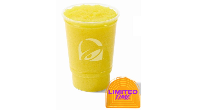 A cup of Taco Bell's Pineapple Freeze on a white background