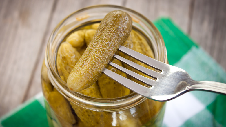 Fork lifting pickle from jar