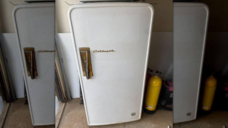 A vintage Coldspot refrigerator in a garage
