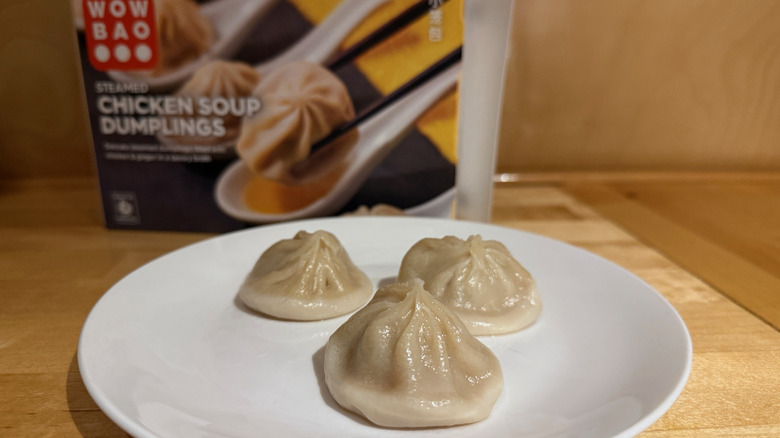 Wow Bao soup dumplings on a plate with a box in background