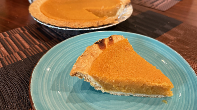 Slice of sweet potato pie on a blue plate