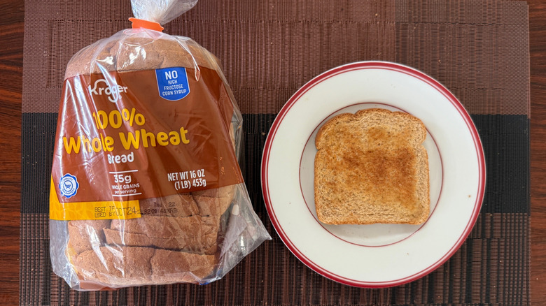 Kroger 100% whole wheat loaf and toasted slice with butter on plate