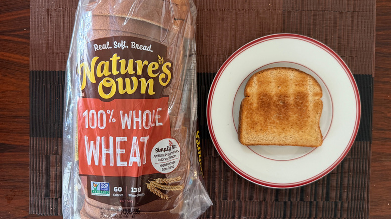 Nature's Own whole wheat loaf and toasted slice with butter on plate
