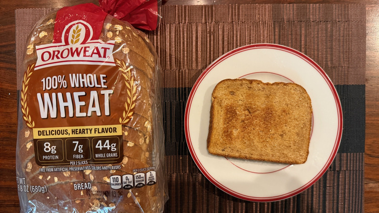 Oroweat wheat loaf and toasted slice with butter on plate