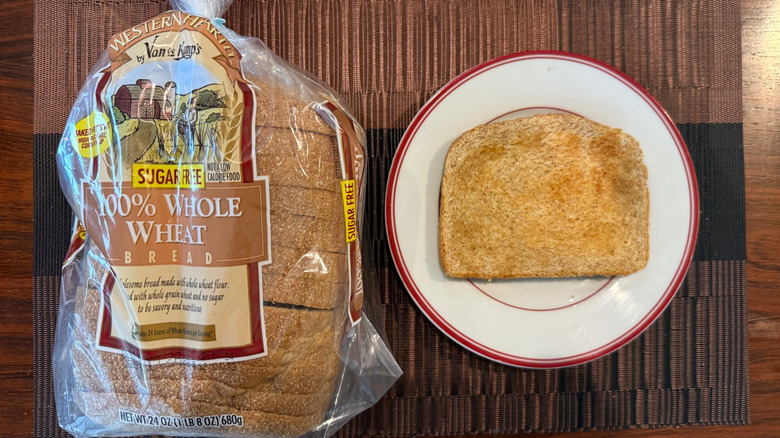 Western Hearth wheat bread in packaging and toasted slice with butter on plate