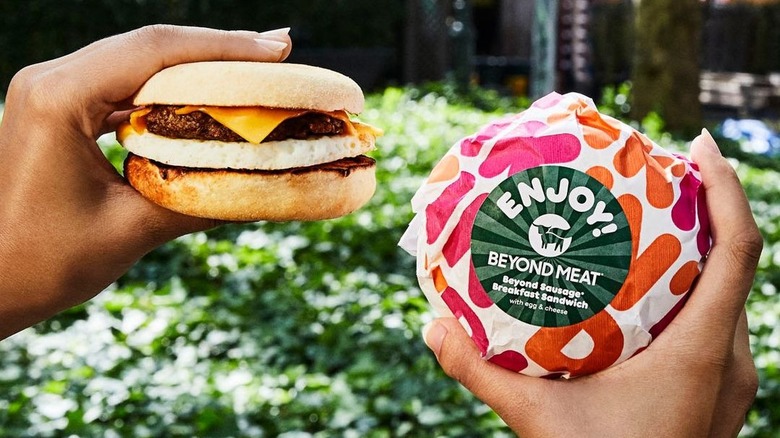 holding dunkin Beyond Sausage Sandwiches