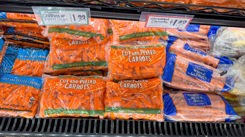 top view of the carrot selection in a Trader Joe's with cut and peeled baby carrots at the forefront