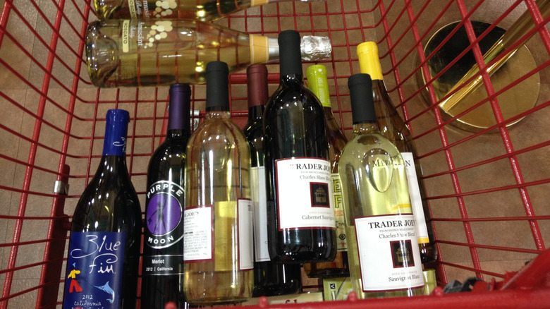 top view of a shopping cart full of Trader Joe's wine with a bottle of Charles Shaw Cabernet Sauvignon on top