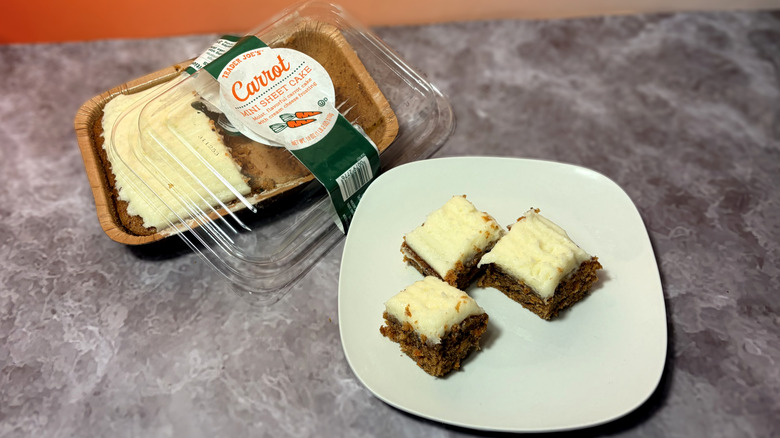 A carrot mini sheet cake in a package and sliced into squares on a plate