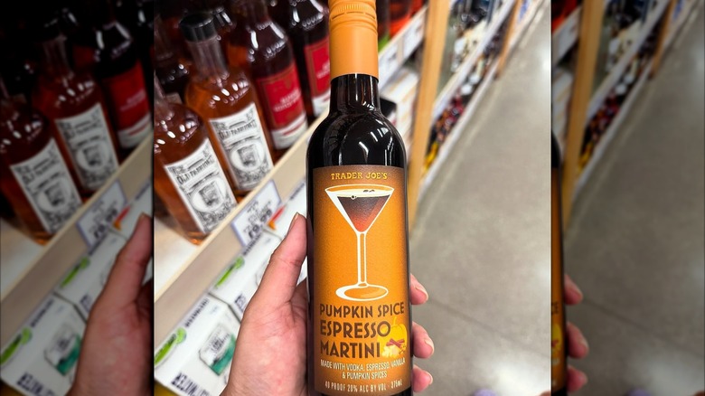 a hand holding a bottle of pumpkin spice espresso martini