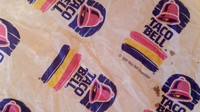 A used wrapper featuring the 1992 version of Taco Bell's logo on it