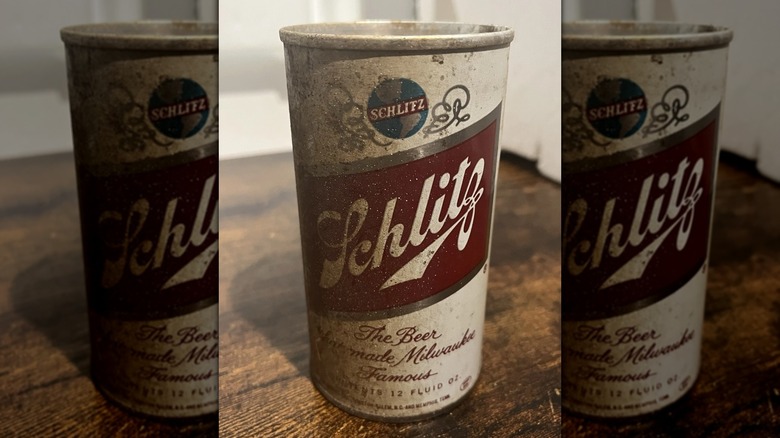 A dirty Schlitz can on a wooden surface