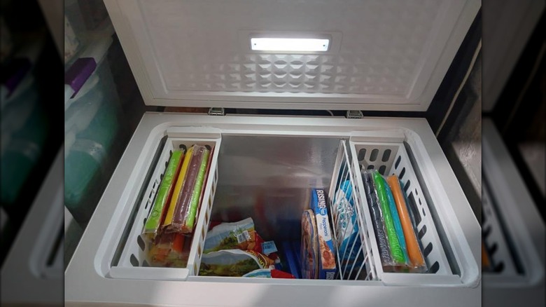 A 5 cubic feet chest freezer open to show food inside