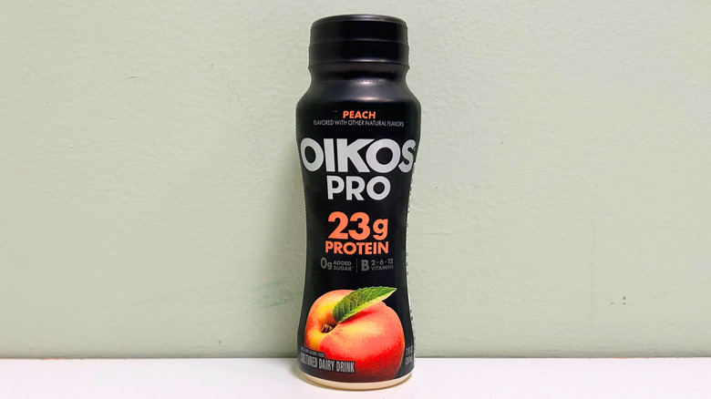 A bottle of Oikos Pro Peach Smoothie