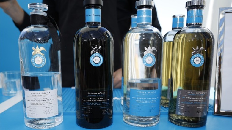 Casa Dragones Sipping Tequila, Añejo, Blanco, and Repsosado bottles in a lineup